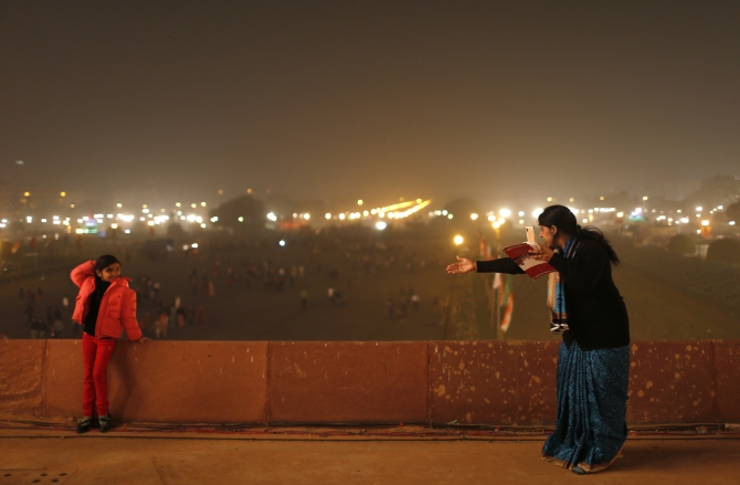 A mother directs her daughter to pose for a photo at the venue for the 'Beating the Retreat' ceremony in New Delhi.