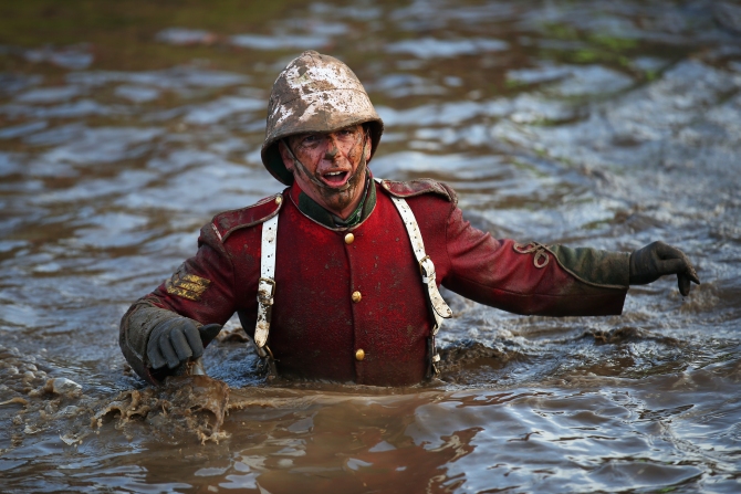 A competitor wades through water during the Tough Guy Challenge in Telford, England.