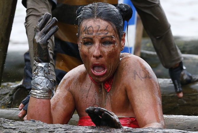 A competitor reacts as she emerges from the water during the Tough Guy event.