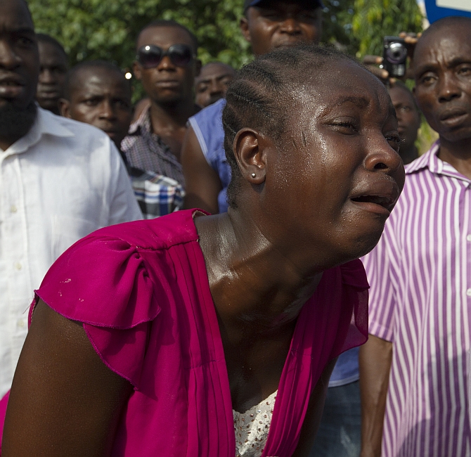 A woman weeps at the scene of bomb blast carried out by Boko Haram at a crowded shopping district in Abuja, Nigeria