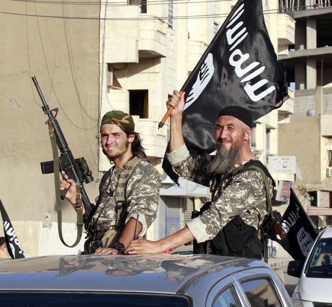 Militant Islamist fighters take part in a parade.