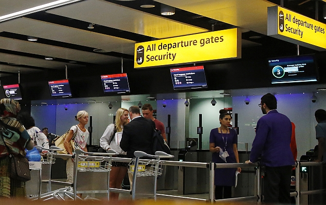 Passengers head towards security control at Heathrow airport in London. Britain has stepped up security at airports after US officials said they were concerned that Al Qaeda operatives were developing bombs that could be smuggled onto planes.