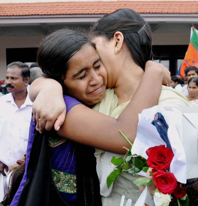 One of the nurses who was stranded in the territory held by Islamic extremists in Iraq, hugs her relative upon arrival at the airport in Kochi on Saturday.