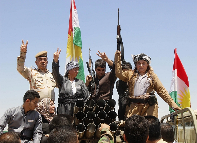  Members of the Kurdish Peshmerga celebrate in the city of Kirkuk