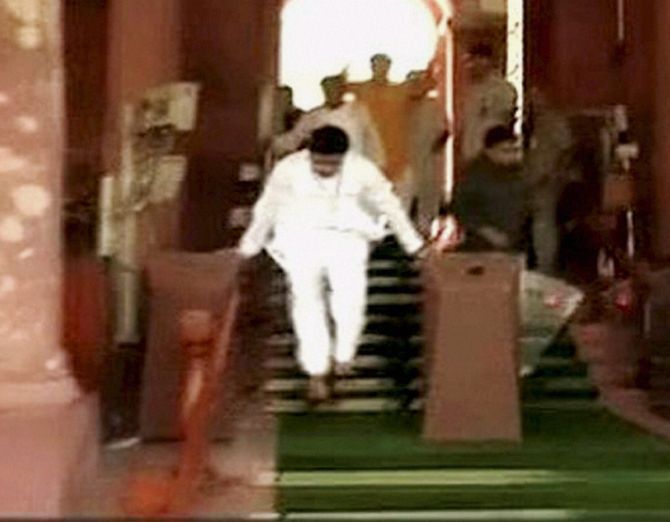 : An MP jumps at the gate as he walks out after a protest in the Lok Sabha over the Rail Budget.