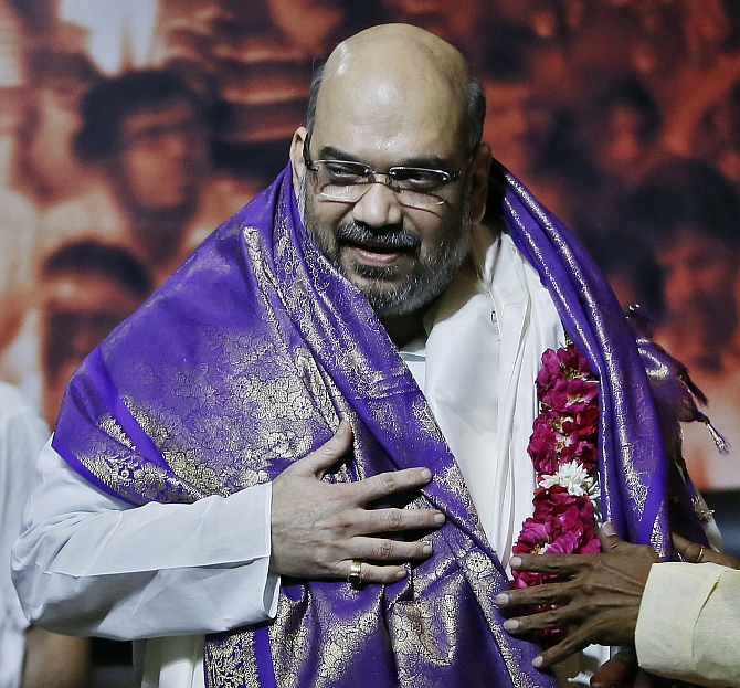 Amit Shah, the newly appointed president of the ruling BJP smiles during a news conference in New Delhi