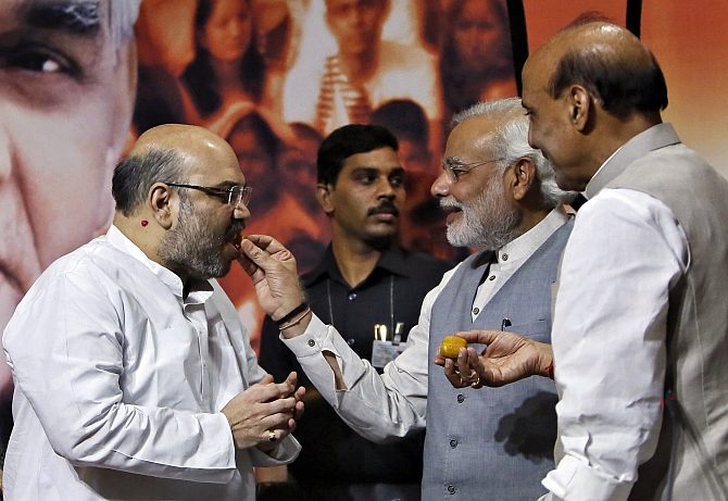 PM Narendra Modi and Home Minister Rajnath Singh offer sweets to Shah