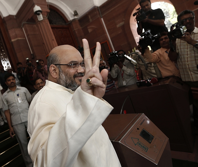 Shah gestures as he arrives to attend the BJP parliamentary party meeting at parliament house in New Delhi
