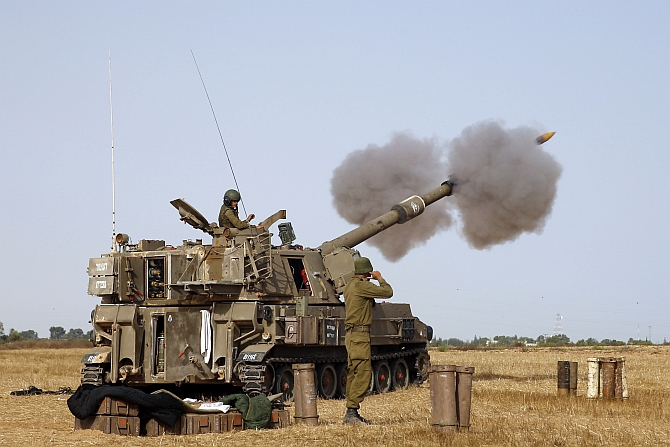  An Israeli mobile artillery unit fires towards Gaza from outside the central Gaza Strip 