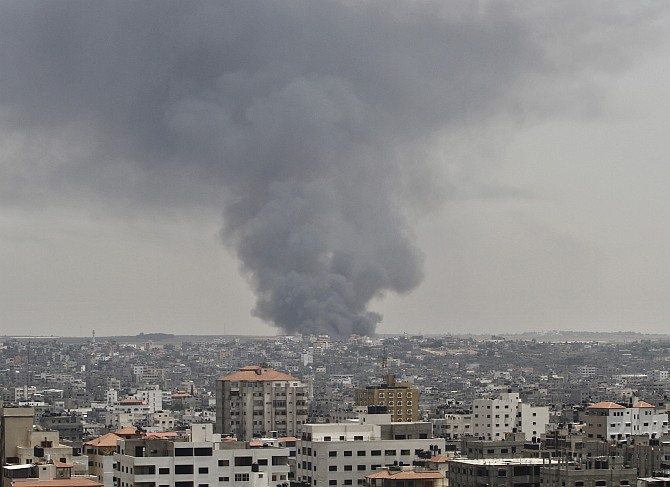 Smoke rises following what police said was an Israeli tank's shelling that hit the industrial area in the east of Gaza City 