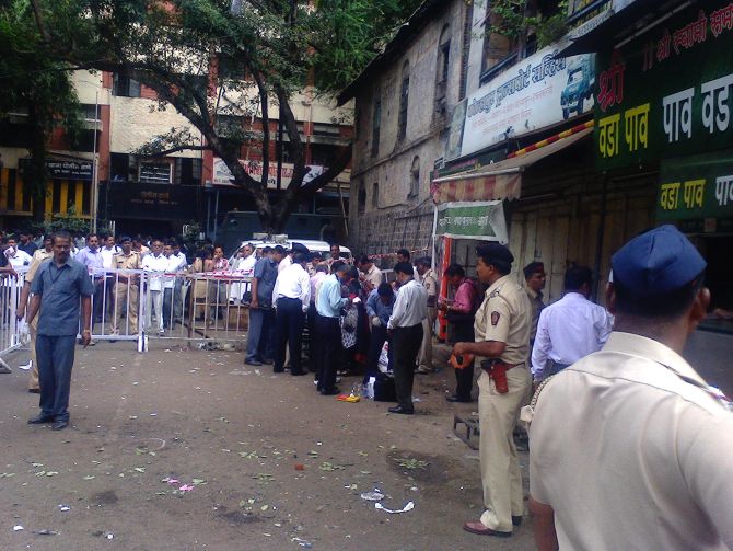 Officials inspect the site of the low-intensity blast in Pune, which injured five people. 