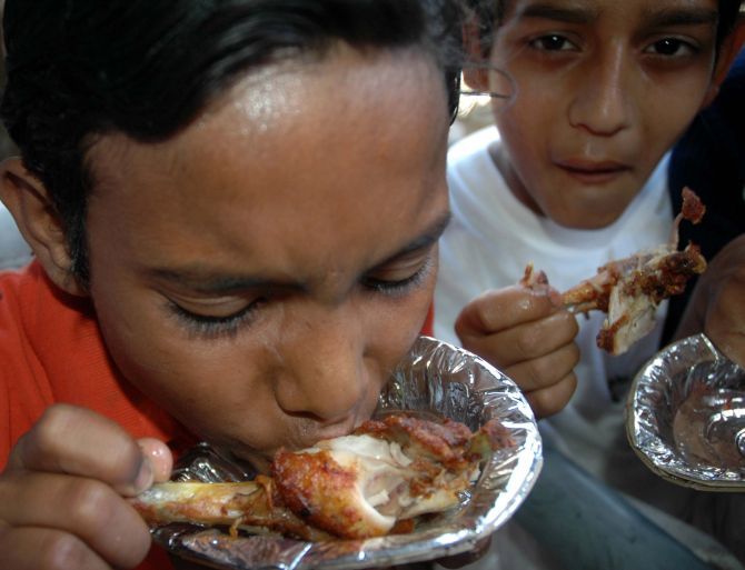 Boys are seen eating chicken during a festival. Image used for representational purposes only. 