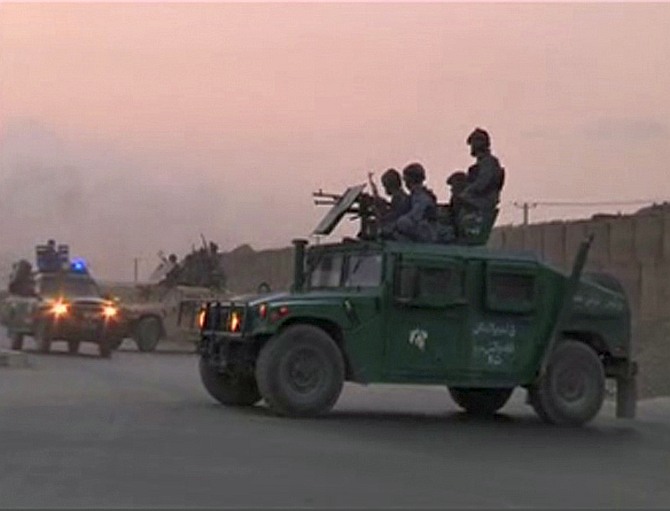 Afghan security personnel are seen on vehicles as an area near the Kabul airport comes under attack, in this still image taken from a Reuters TV video in Kabul 
