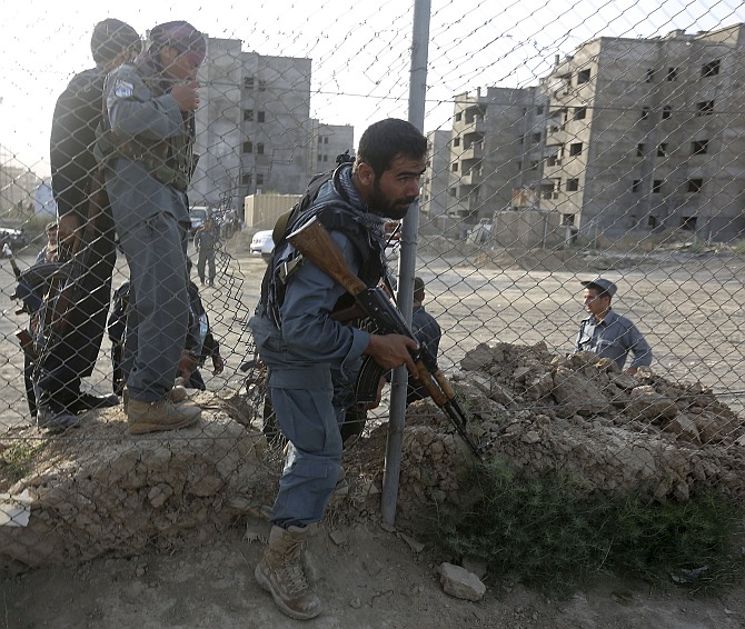 Afghan policemen arrive at the site of an attack in Kabul