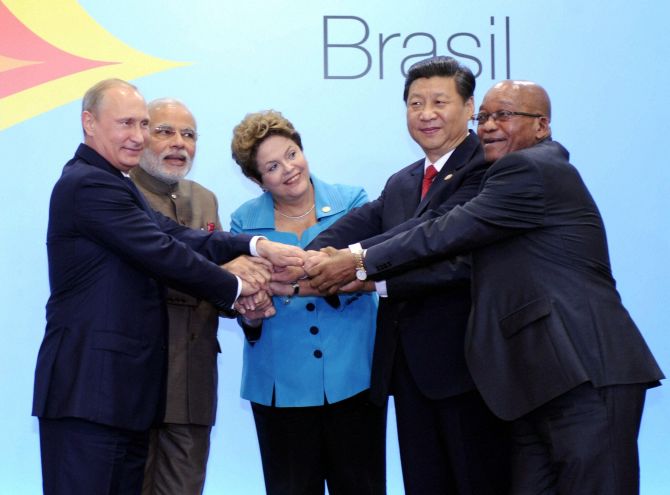 Prime Minister Narendra Modi join hands with Brazil's President, Dilma Rousseff, Russian President Vladimir Putin and Chinese President, Xi Jinping and South African President Jacob Zuma during the official photo of 6th BRICS summit.