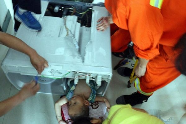 Fire officials cut open the washing machine and rescue the toddler