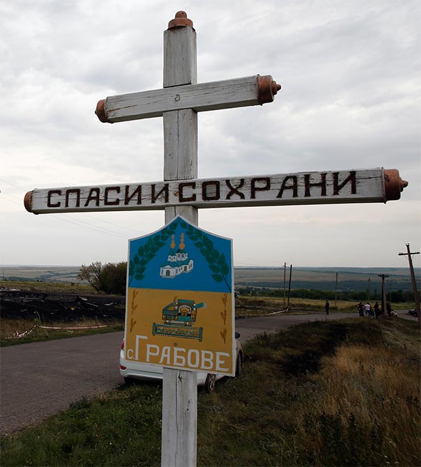 The village sign of Grabovo near the debris of the Malaysia Airlines Boeing 777.