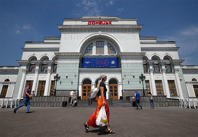 People walk past the train station in Donetsk.