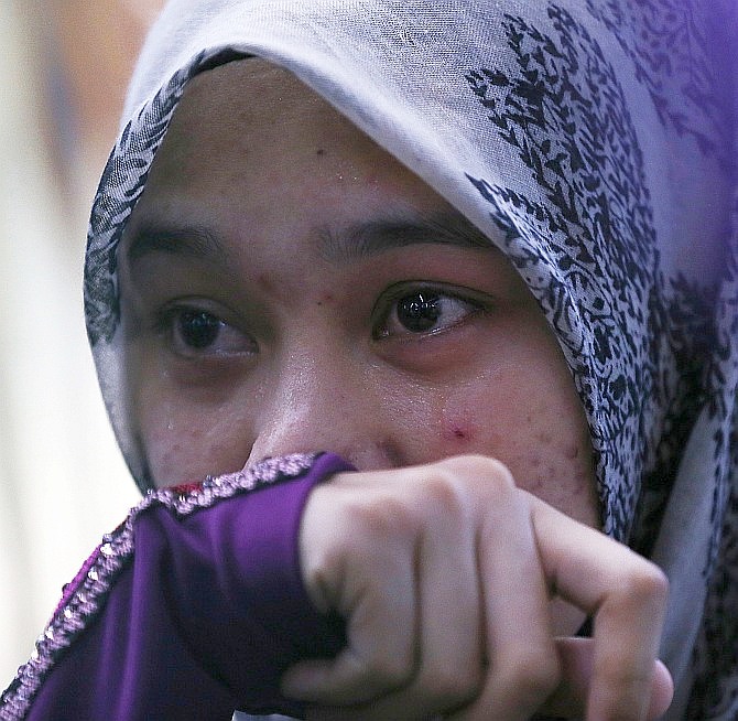 Atikah Abdul Rahman, 20, the niece of Captain Wan Amran, who was on board Malaysia Airlines flight MH17, arrives at Kuala Lumpur International Airport in Sepang July 18