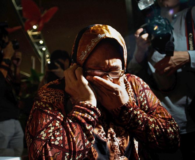 A Malaysian woman weeps after she hears of the crashing of the plane.