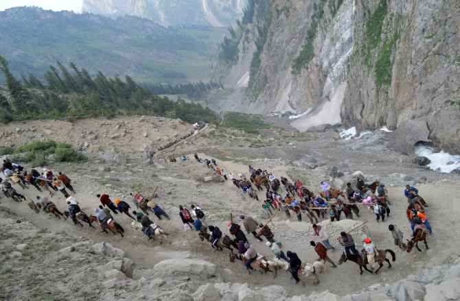 Pilgrims proceed towards the Holy Amarnath shrine from Baltel route on Saturday