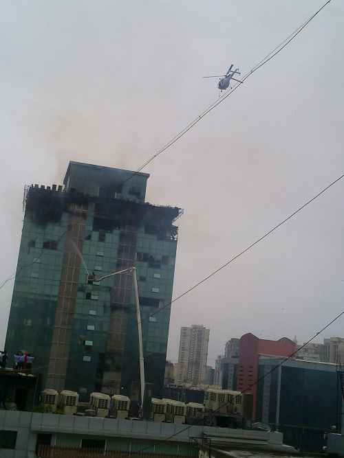 Navy chopper in action to rescue trapped firemen at Lotus Business Park in Mumbai on Friday