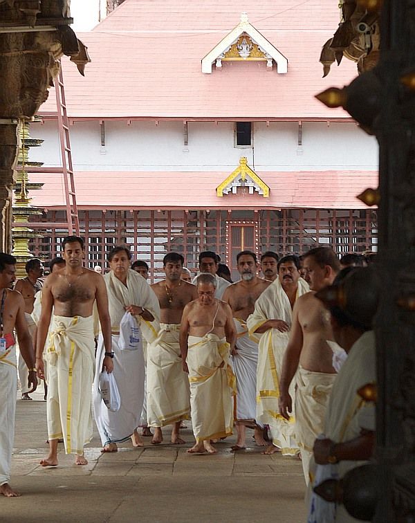 President Pranab Mukherjee at the Sree Padmanabhaswamy temple in Thiruvananthapuram, July 19, 2014. He is flanked by Congress MP Shashi Tharoor on his right and on his left by Venu Rajamony (with beard), then press secretary to the President. Photograph: Rashtrapati Bhavan