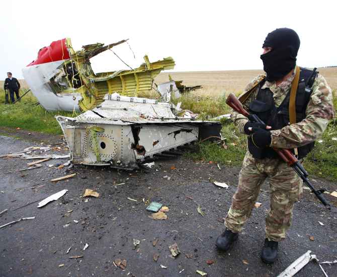 A pro-Russian separatist stands at the crash site of Malaysia Airlines flight MH17, near the settlement of Grabovo in the Donetsk region of Ukraine.