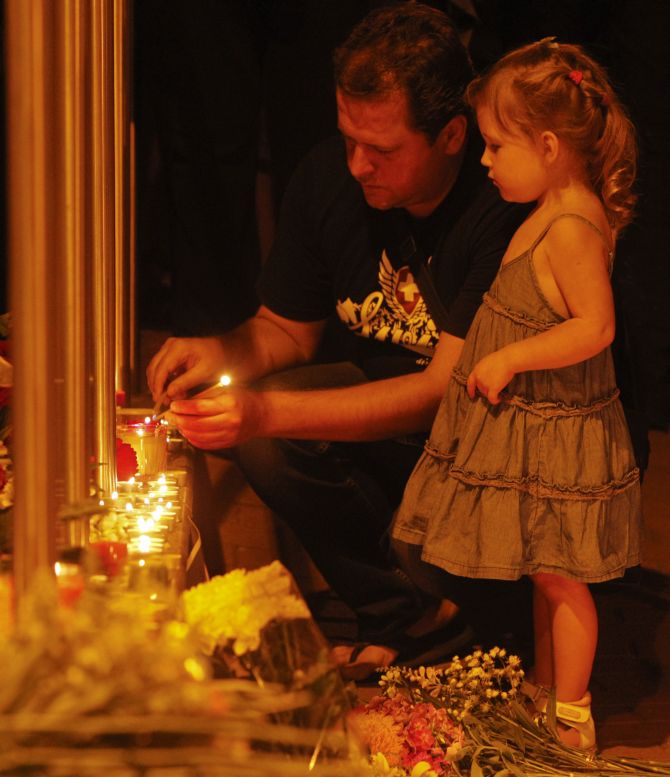People light candles at the Dutch embassy for the victims of Malaysia Airlines MH17, which crashed in eastern Ukraine