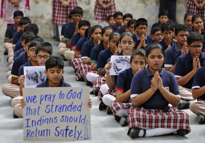 School students pray for the Indian citizens kidnapped in Iraq, at a school in Ahmedabad.