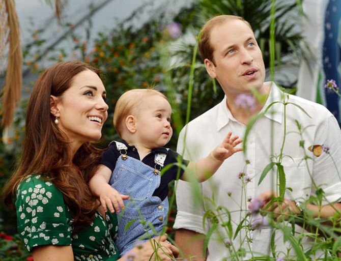 Britain's Catherine, Duchess of Cambridge, carries her son Prince George alongside her husband Prince William as they visit the Sensational Butterflies exhibition at the Natural History Museum in London.