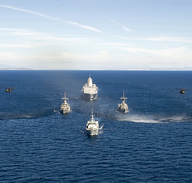 San Antonio-class amphibious transport dock ship USS Anchorage (LPD 23), Avenger-class mine countermeasures ships USS Scout (MCM 8) and USS Champion (MCM 4), and Canadian Forces Kingston-Class coastal defense vessel HMCS Nanaimo (MM 702) transit in formation off the coast of Southern California as part of Rim of the Pacific Exercise 2014. 