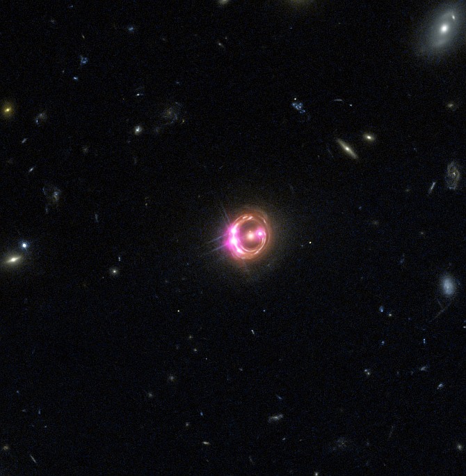 Multiple images of a distant quasar are visible in this combined view from NASA's Chandra X-ray Observatory and the Hubble Space Telescope. The Chandra data were used to directly measure the spin of the supermassive black hole powering this quasar. This is the most distant black hole where such a measurement has been made, as reported in our press release.