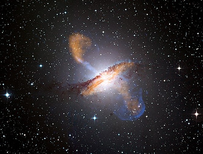 NASA's Chandra X-ray Observatory has helped create a spectacular view of Centaurus A that shows the effects of a supermassive black hole. At the center of this nearby galaxy, a central black hole powers jets and lobes that flare against a background of stars and stardust. In the upper left of the image, an X-ray jet extends about 13,000 light years away from the black hole. The material in that jet is travelling at about half the speed of light.