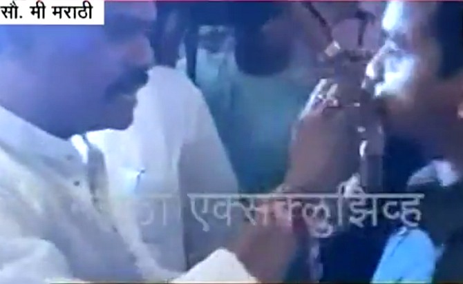 Video grab showing Shiv Sena's Thane MP Rajan Vichare force-feeding Arshad