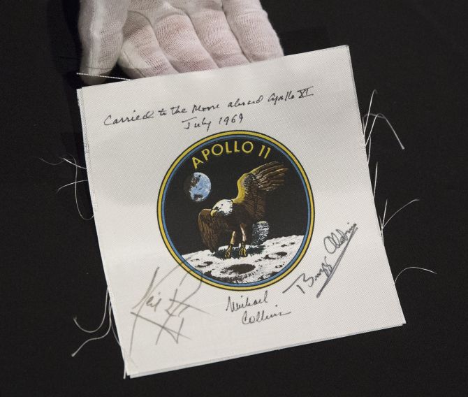 An Apollo 11 emblem, flown into lunar orbit and signed by the crew - Neil Armstrong, Michael Collins, and Buzz Aldrin, is displayed as part of the upcoming Space History Sale at Bonham's auction house in New York.