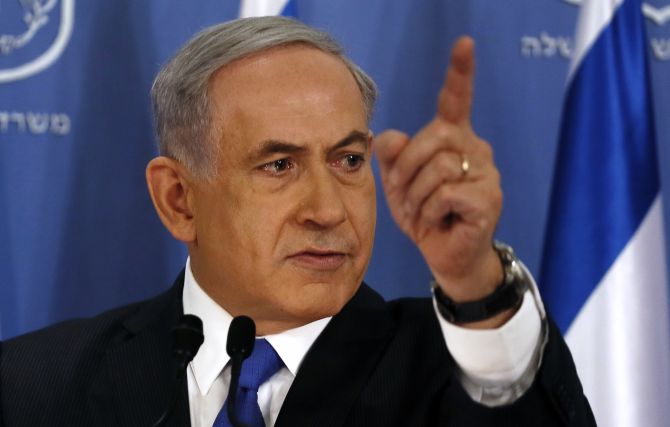 Israeli Prime Minister Benjamin Netanyahu gestures as he speaks during a news conference at the defense ministry in the Israeli coastal city of Tel Aviv