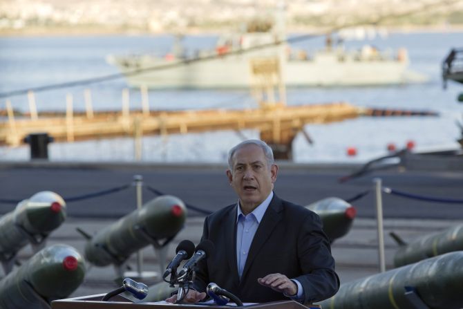 Israel's Prime Minister Benjamin Netanyahu speaks to the media in front of a display of M302 rockets, found aboard the Klos C ship, at a navy base in the Red Sea resort city of Eilat