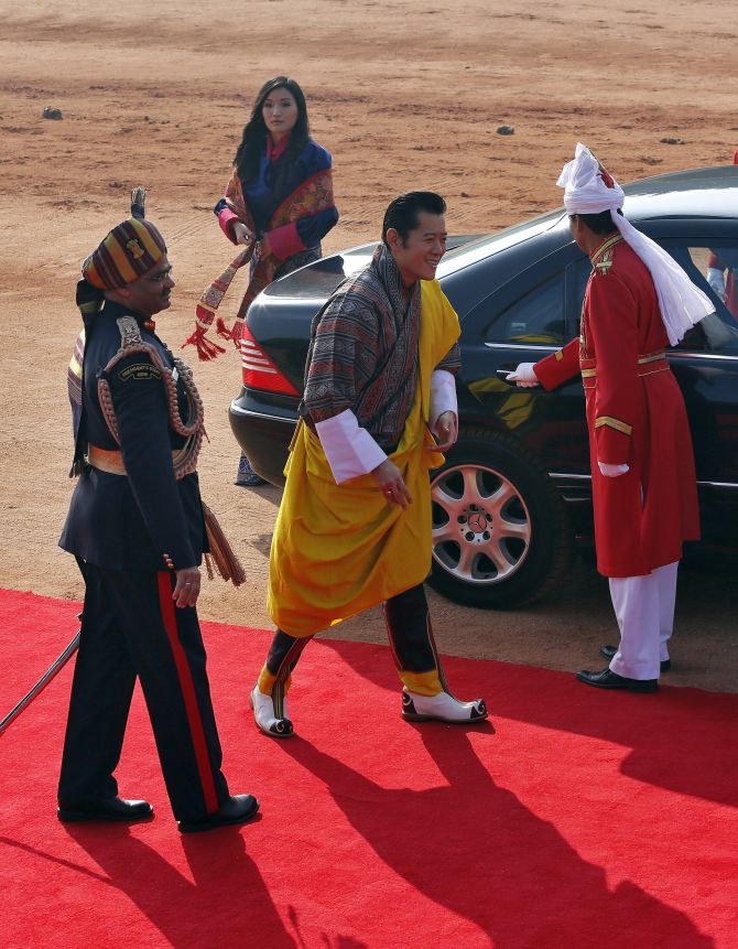 Bhutan's King Jigme Khesar Namgyel Wangchuck (2nd R) arrives with Queen Jetsun Pema (2nd L) to inspect a guard of honour during his ceremonial reception at the forecourt of India's presidential palace Rashtrapati Bhavan in New Delhi January 25, 2013