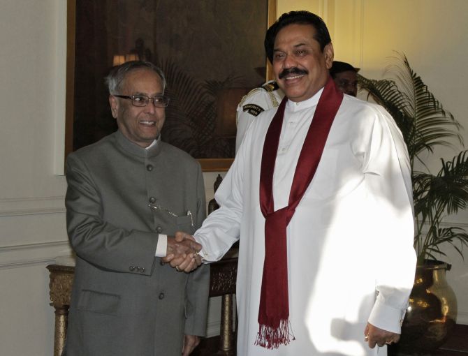 Sri Lanka's President Mahinda Rajapaksa (R) shakes hands with his Indian counterpart Pranab Mukherjee during their meeting at India's presidential palace Rashtrapati Bhavan in New Delhi September 20, 2012