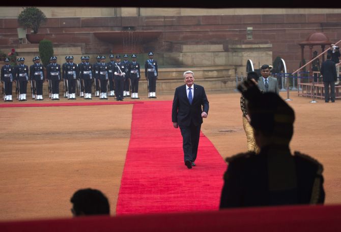 German President Joachim Gauck walks on the red carpet during his ceremonial reception at the forecourt of India's Rashtrapati Bhavan presidential palace in New Delhi February 5, 2014.