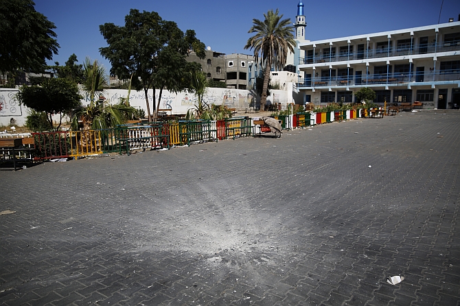 A crater marks the centre of a courtyard at a UN-run school sheltering Palestinians displaced by an Israeli ground offensive, that police said was hit by an Israeli shell, in Beit Hanoun in the northern Gaza Strip
