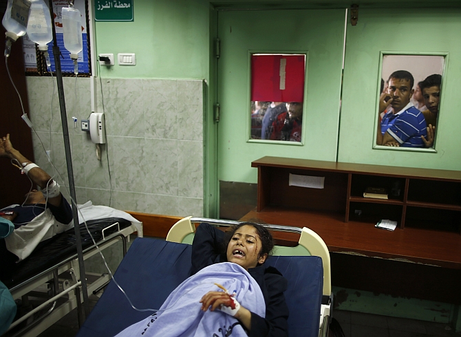 A Palestinian girl wounded in the school lies in a hospital bed