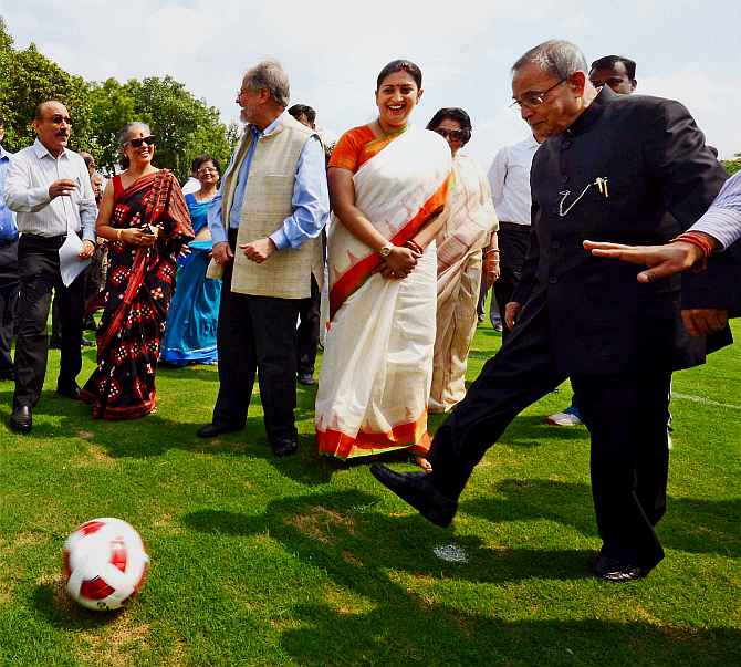 President Pranab Mukherjee kicks a football as HRD Minister Smriti Irani looks on during inauguration of various facilities in Rashtrapati Bhavan on Friday. 