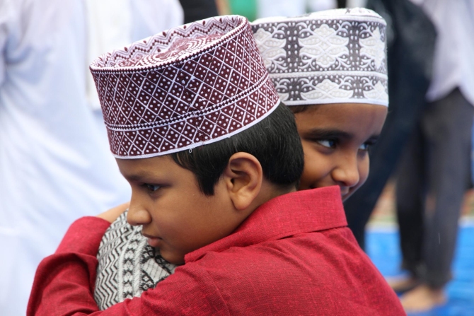 Young boys congratulate each other after saying their Eid-ul-Fitr prayers in Thane.