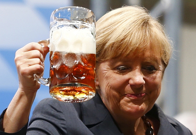 German Chancellor Angela Merkel toasts with beer after her speech in Dachau near Munich 