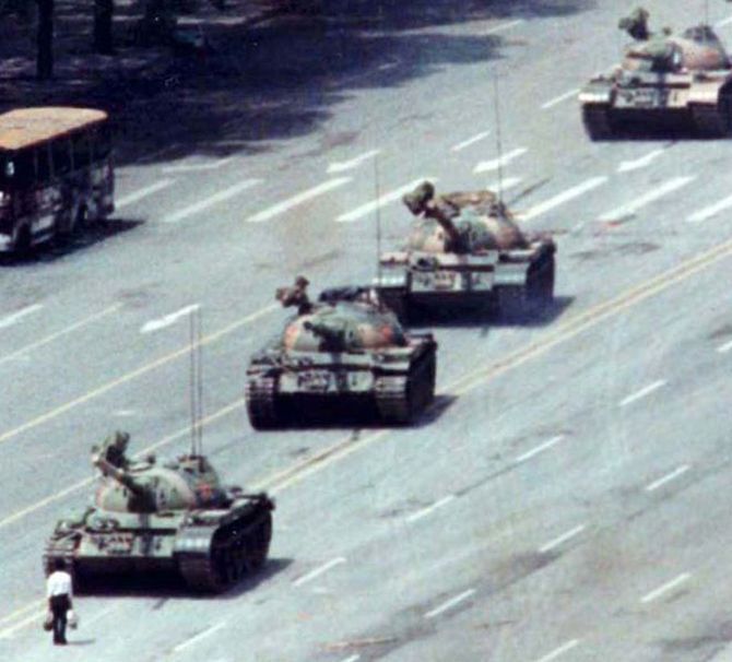 The unforgettable 'tank man' stands in front of a line of tanks during the protests.