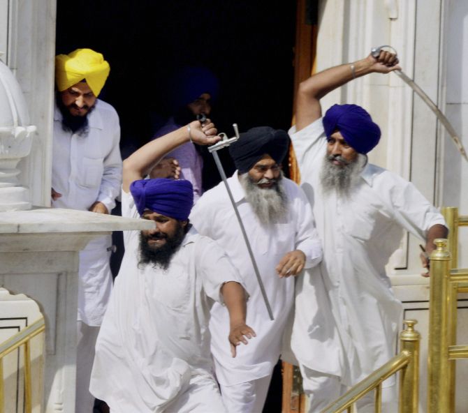 Sikhs brandishing swords during a clash between SGPC and members of a radical Sikh organisation on the occasion 30th anniversary of Operation Bluestar, at Golden Temple Complex in Amritsar