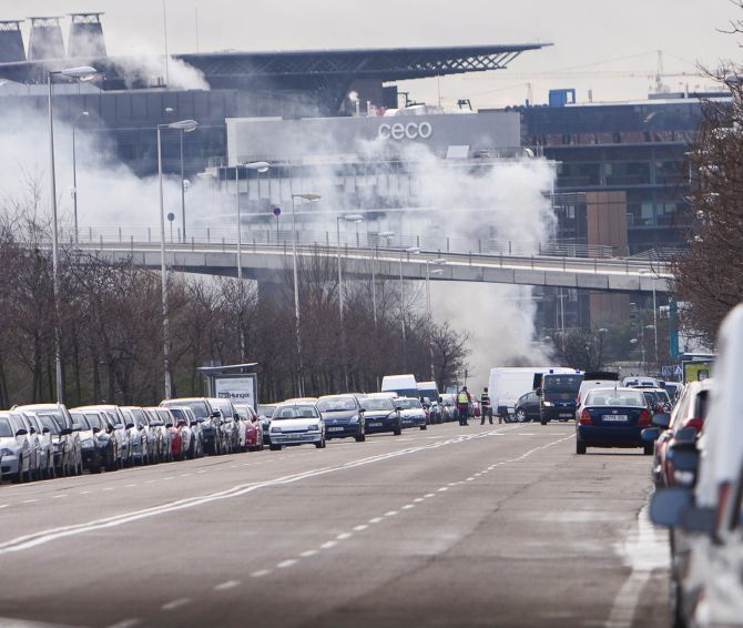 Smoke billows from the airport after a van bomb exploded in the parking area.