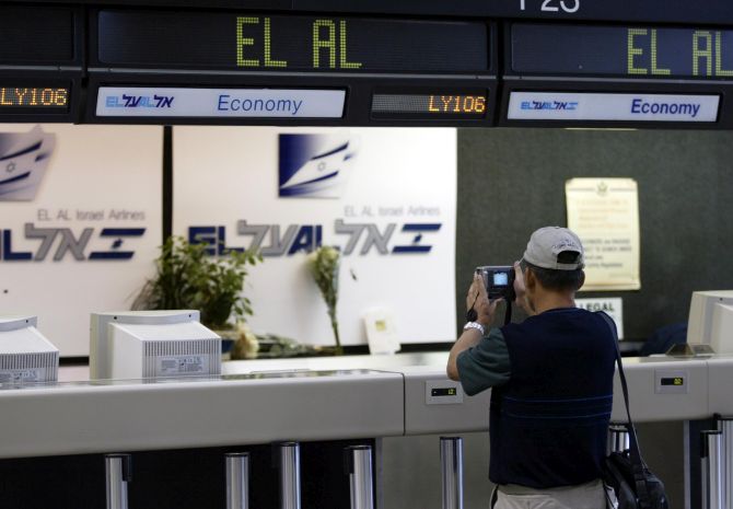 A tourist takes a photo of the ticket counter where the terrorist had pulled out two pistols and open fired on the passengers.